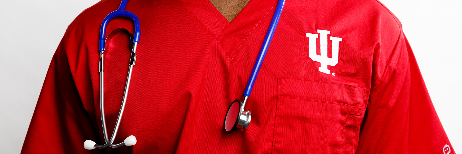 Close up of a nursing uniform with a trident and stethoscope