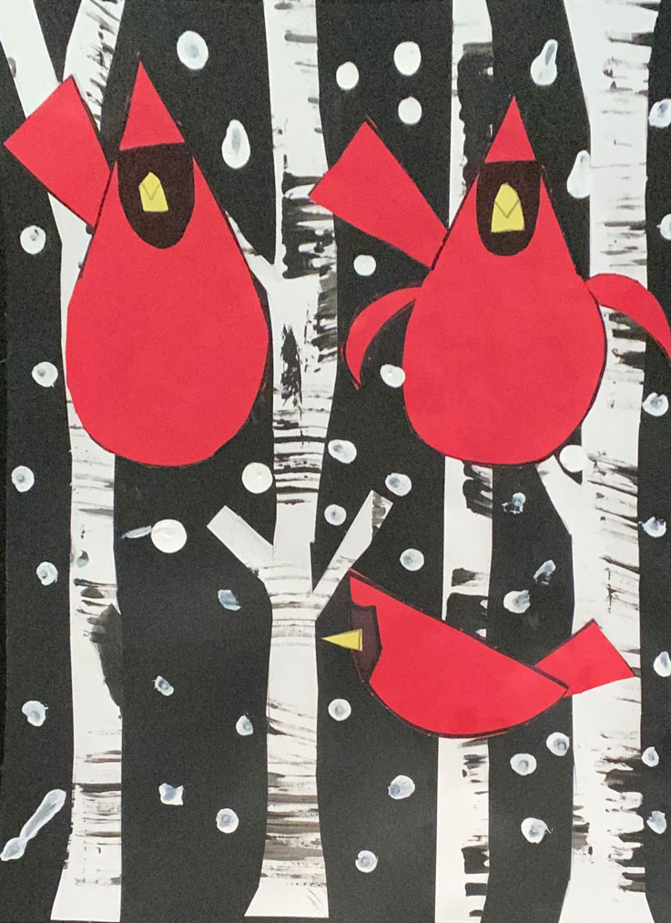 A paper art piece of cardinals in winter.