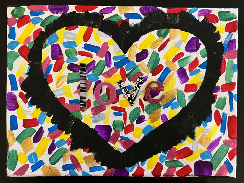 Child's artwork of a heart with the word 'love' in the middle, and with multiple strokes of paint in many colors in the background.