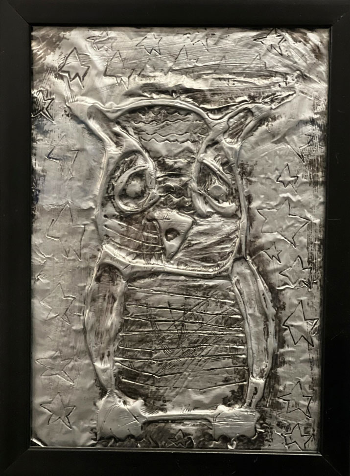 A foil art piece of an owl.