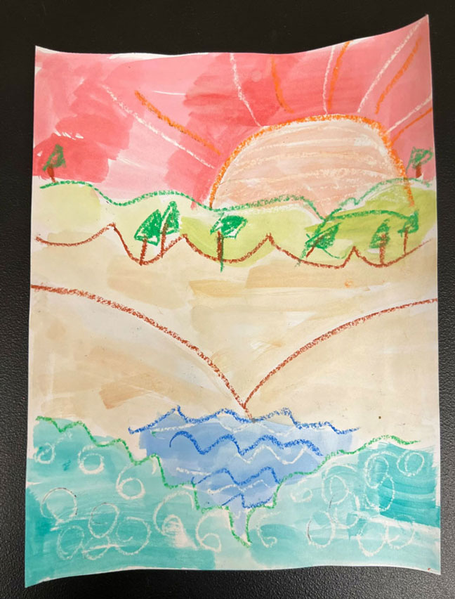 Child's painting of a sunset on the beach.