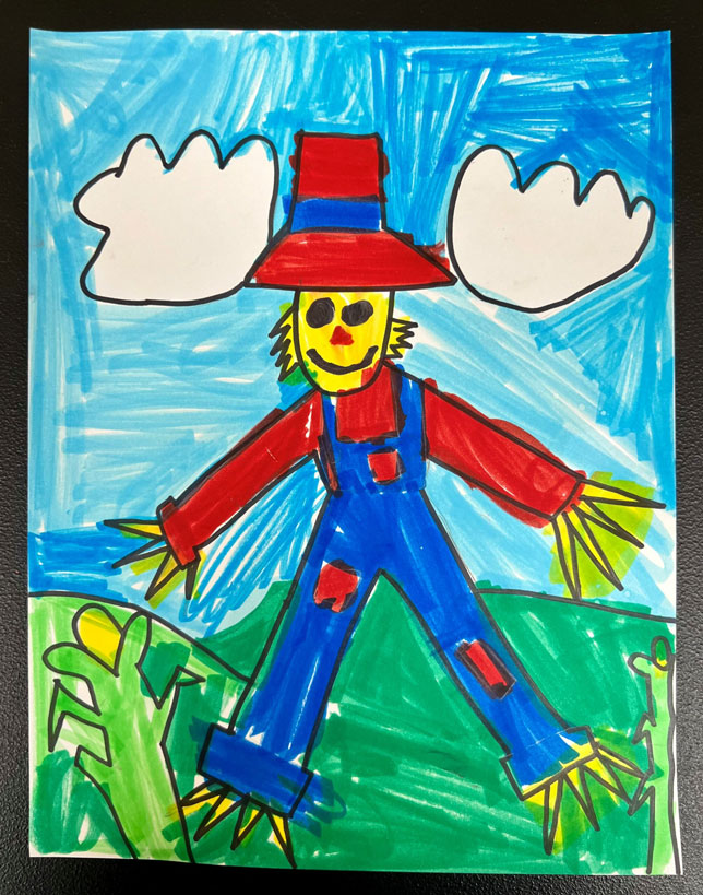 A child's marker-colored artwork of a blue, red and yellow scarecrow.