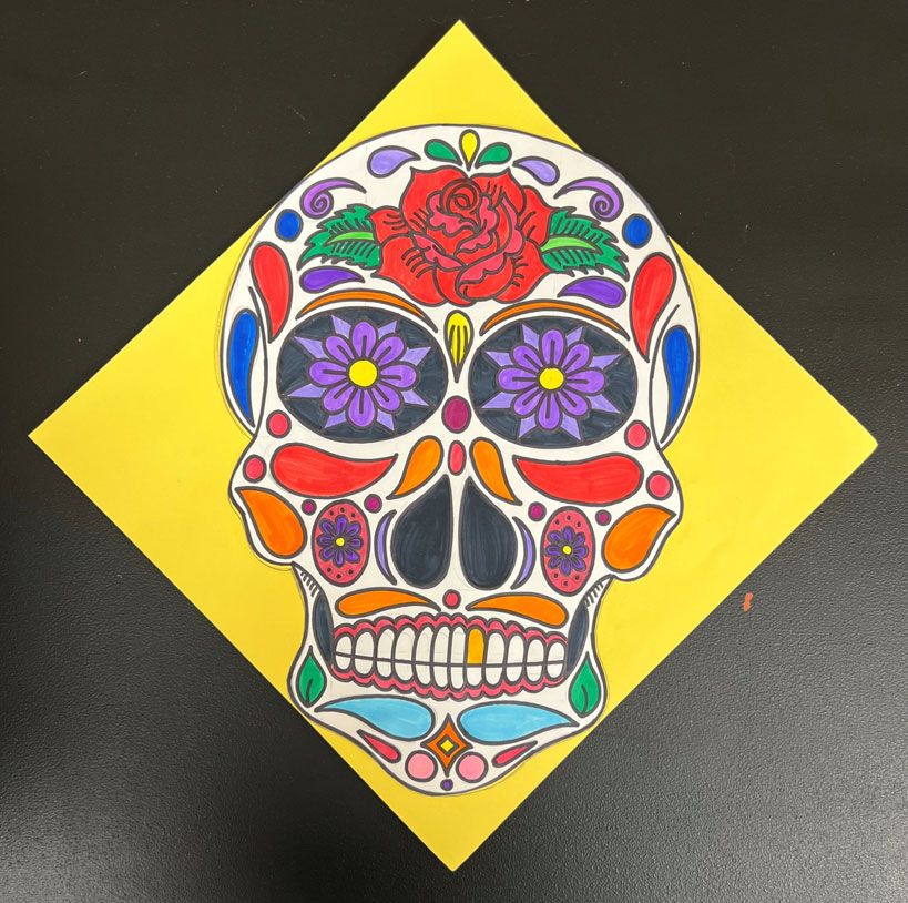 An artwork of a skull, adorned with multicolored flowers and other decorations. Looks to be inspired by Day of the Dead.